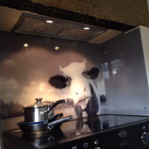 A photo of a cow on a stove top.
