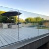 A deck with a glass railing.